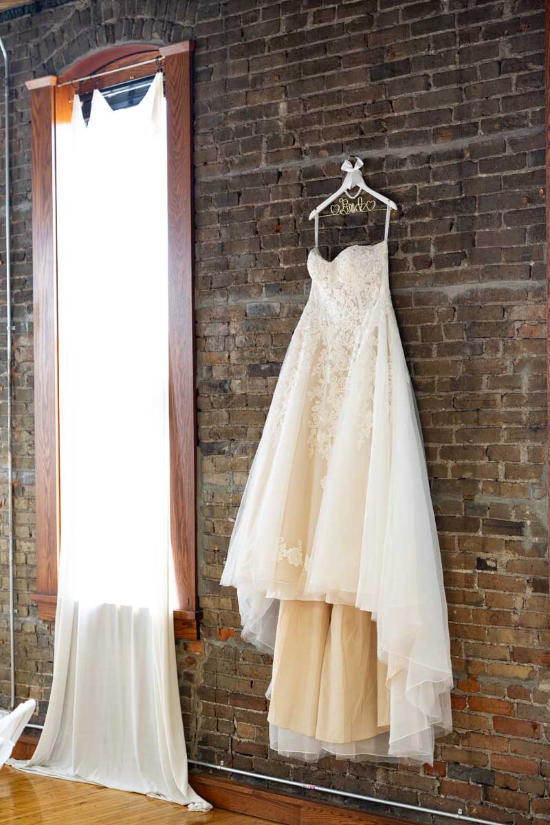 the promise room minnesota wedding venue-dress on wall